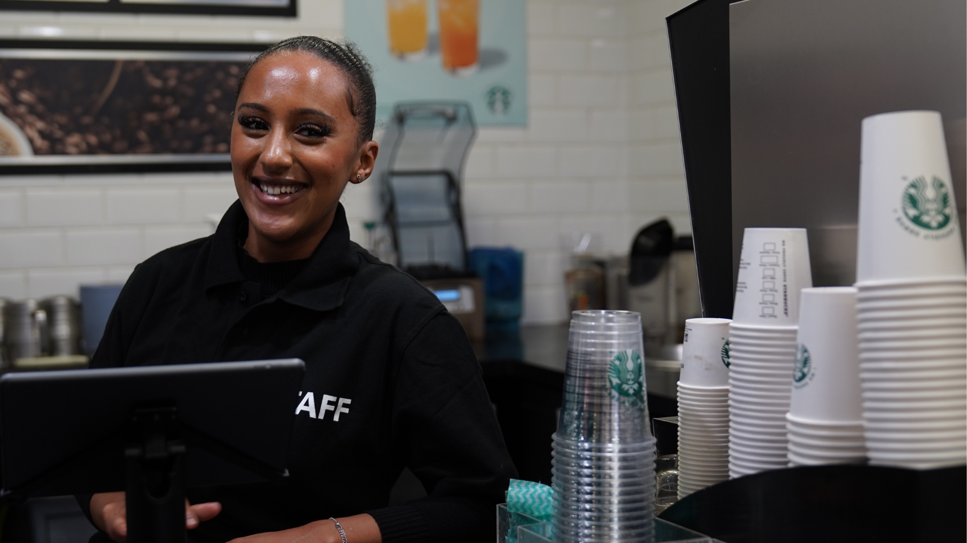 Staff member at the counter smiling