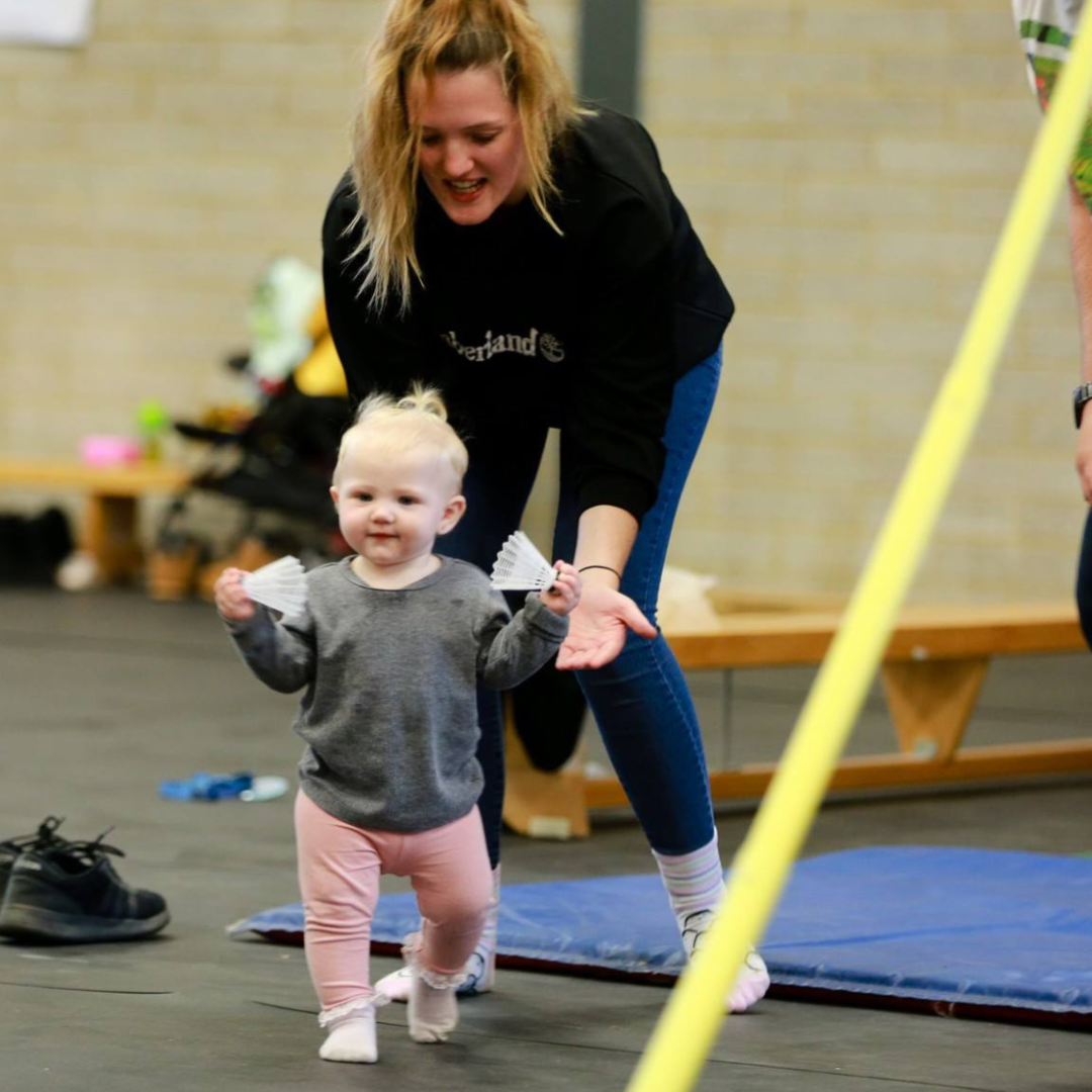 woman and baby playing in sports hall at avery hill campus